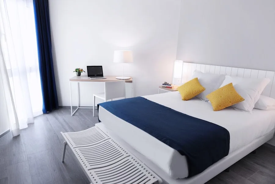 Bright hotel room with desk.