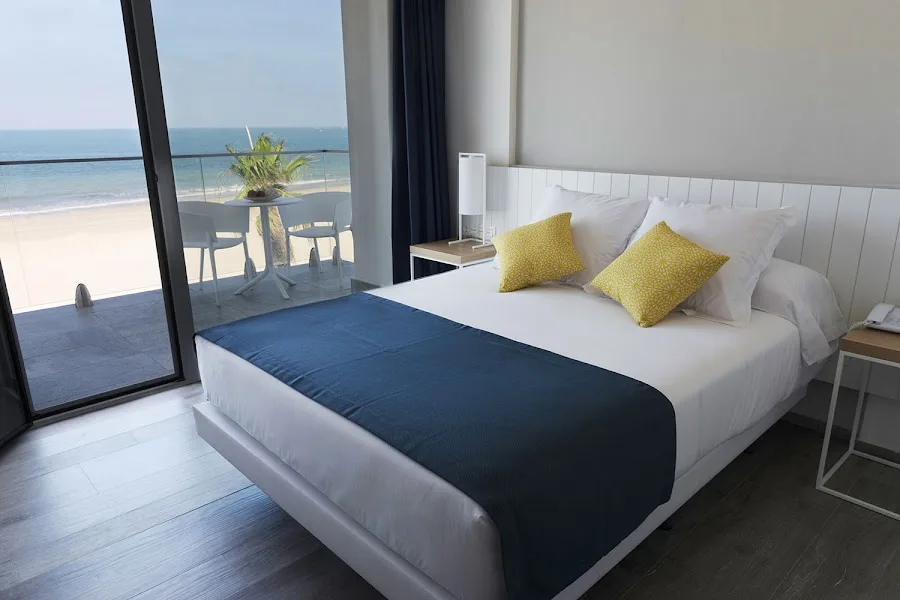 Hotel room with balcony and sea views.