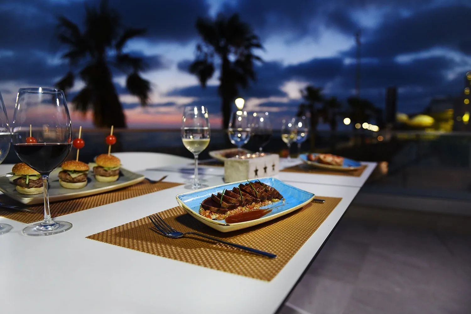 Hotel terrace dining at sunset.