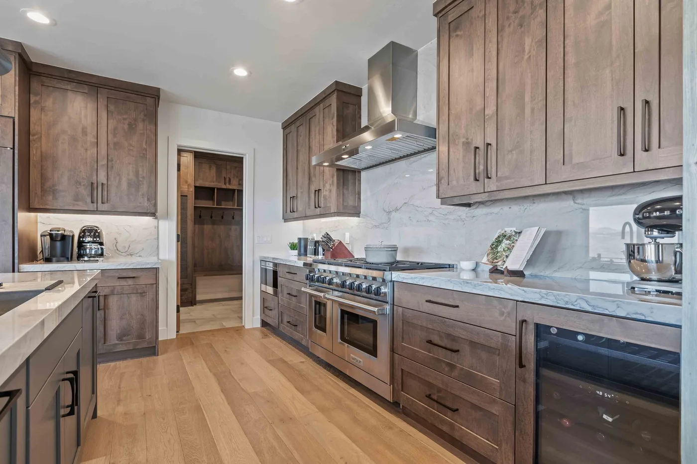 A kitchen with wood cabinetry, countertops, and built-in appliances.