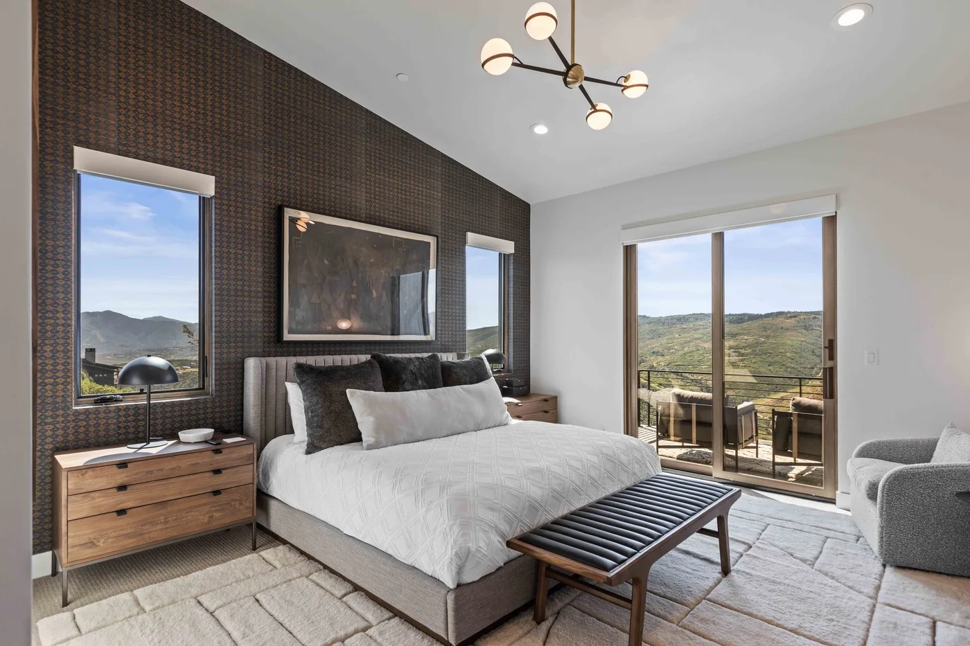 A bedroom with a bed and sliding glass doors opening onto a balcony.