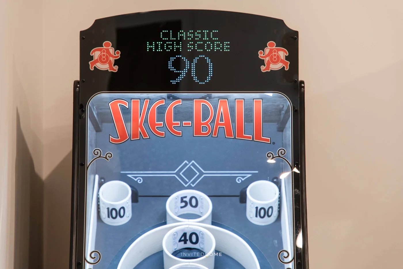 An arcade skee-ball game with a digital high-score display.
