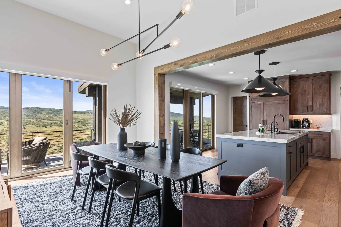 An open dining and kitchen area with a long table and an island.