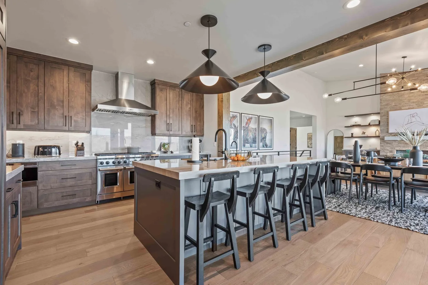 An open-plan kitchen and dining area with a long island and bar seating.
