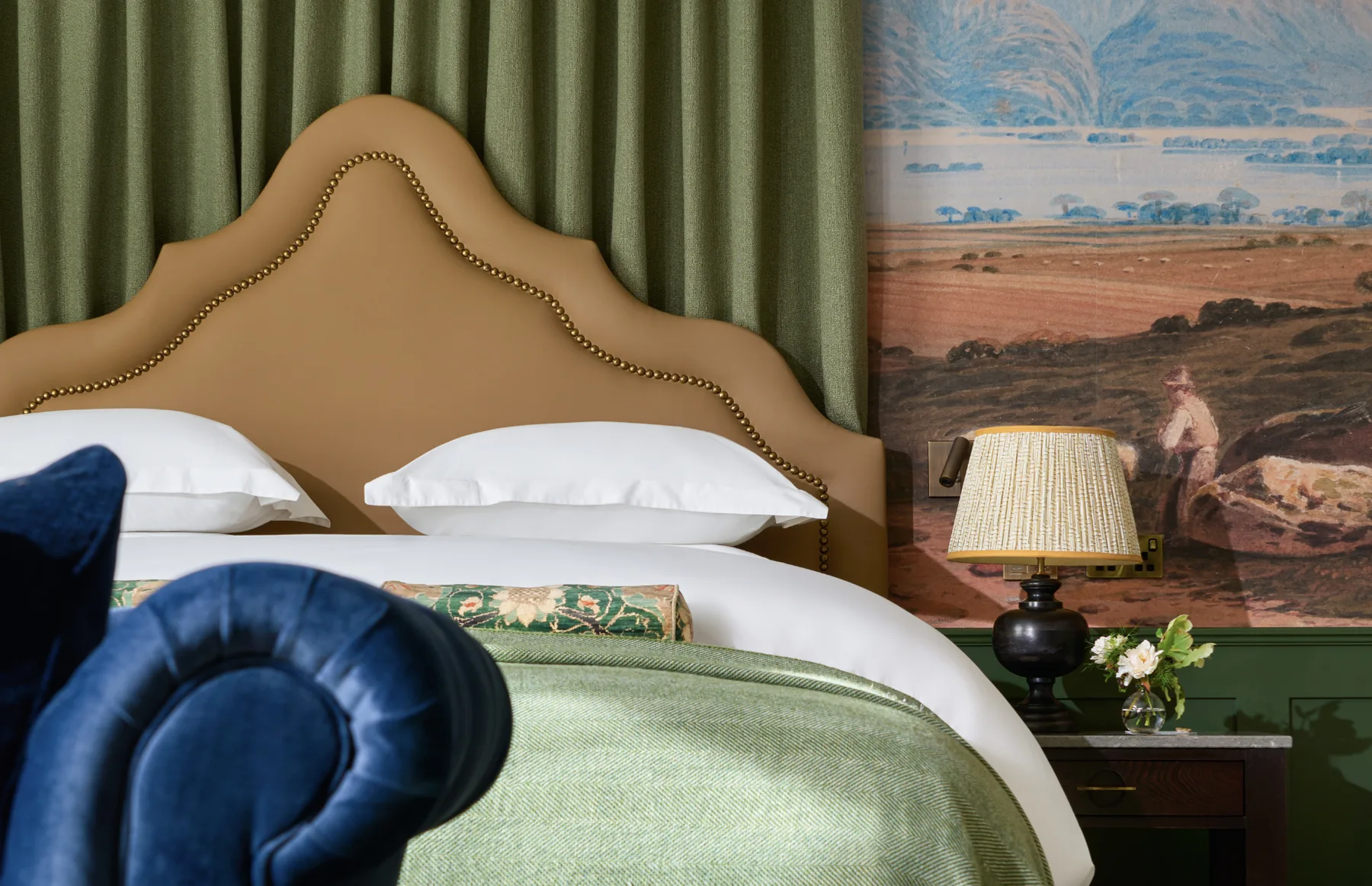Cama king y mesita de noche con papel pintado de temática de Kerry