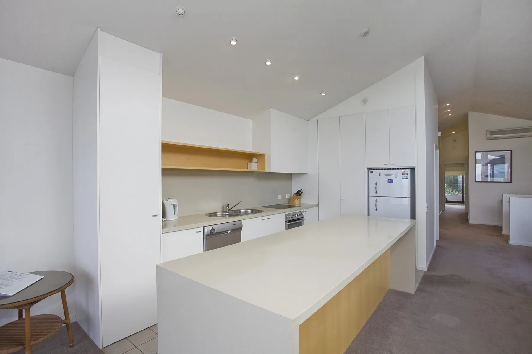 A bright kitchen with white cabinetry and a long island counter.