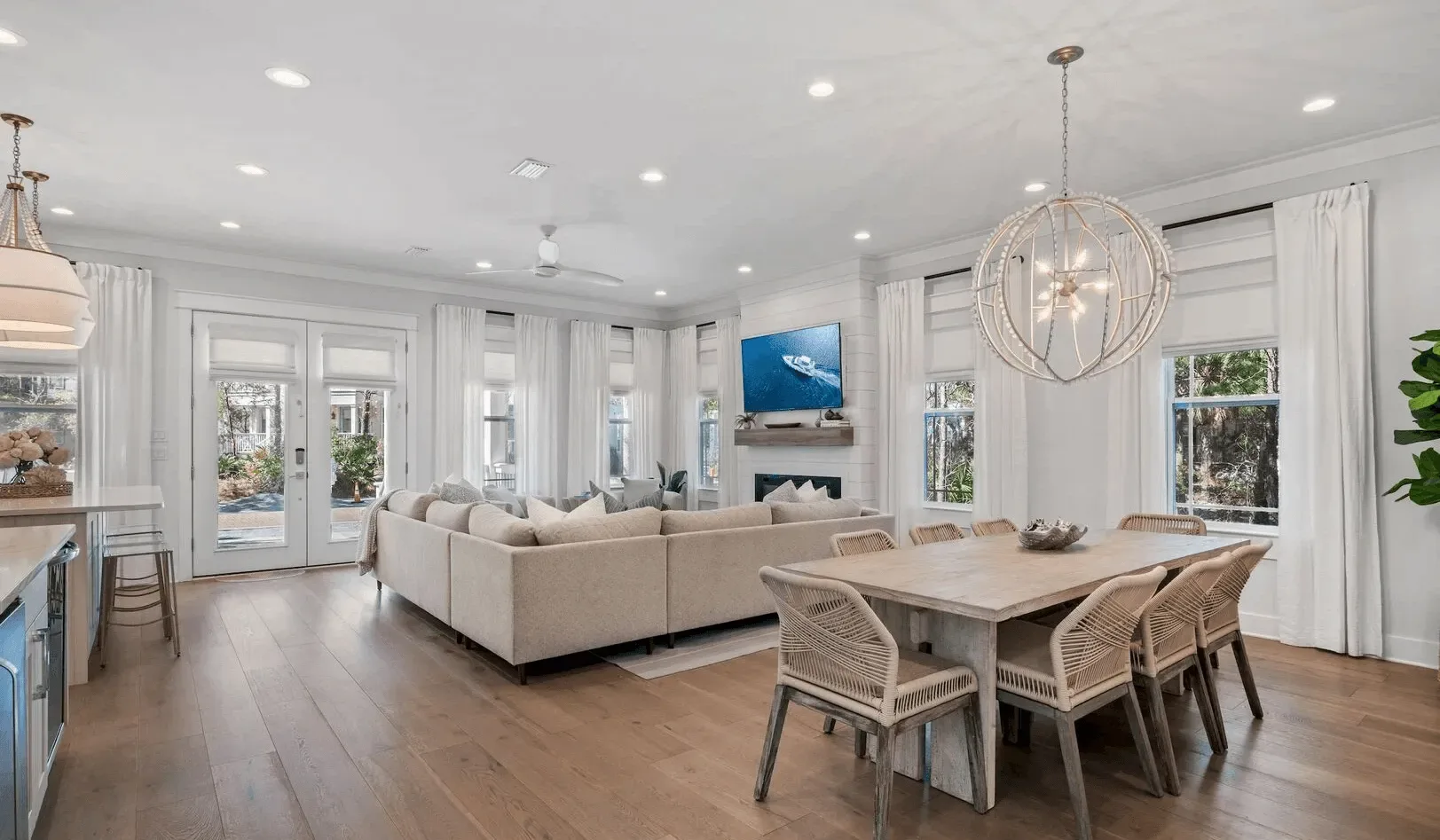 An open living and dining area with a sectional seating area and dining table.