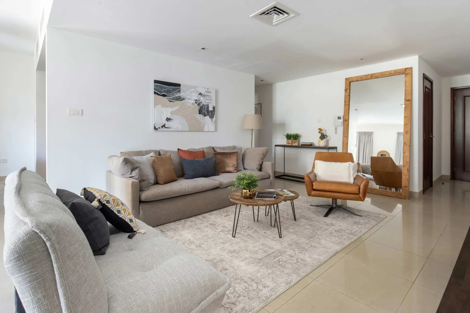 A bright living room with seating arranged around a coffee table.