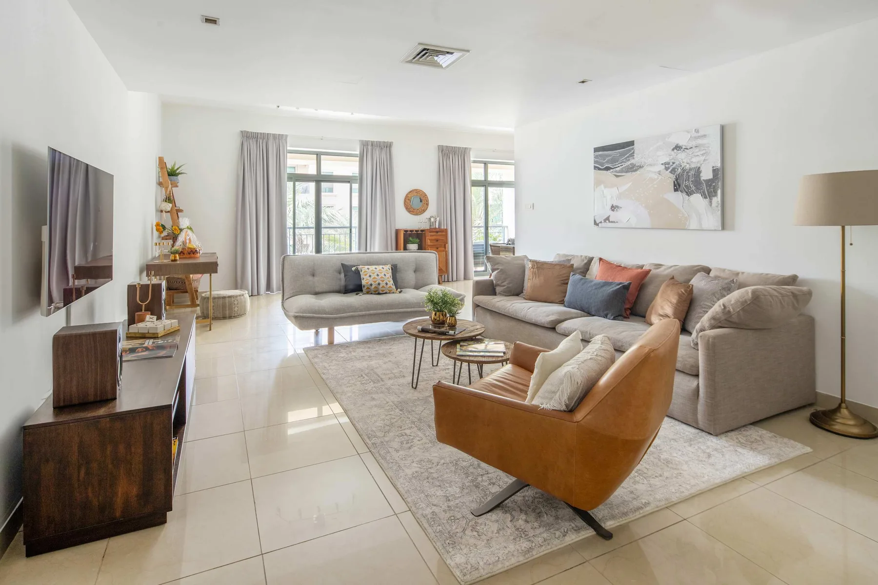 A bright living room with seating arranged around a coffee table.