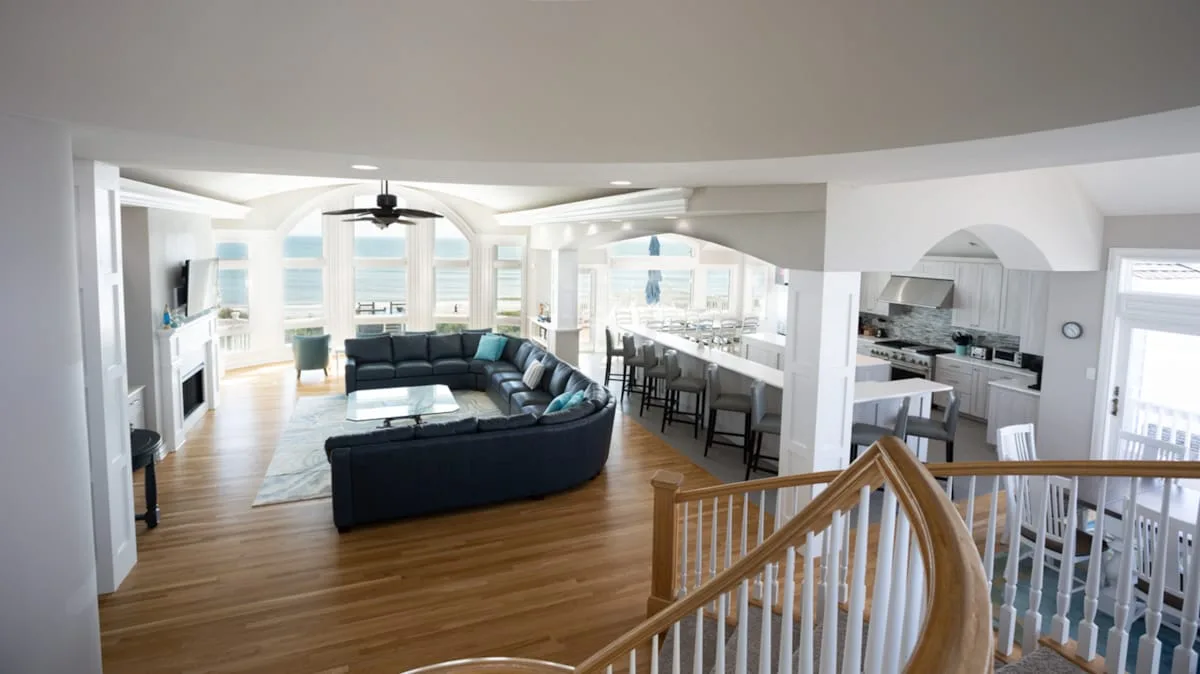 An open-plan living area with a curved seating area and kitchen island.