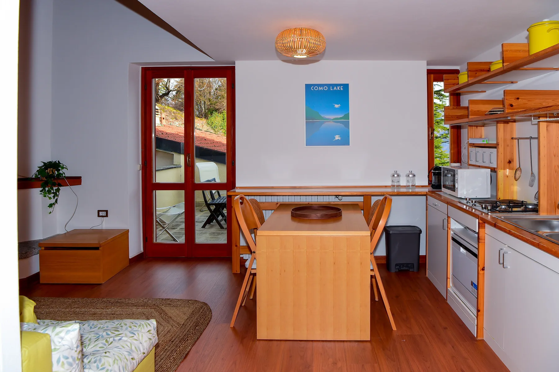 A kitchen and dining area with wooden cabinets, a table, and chairs.