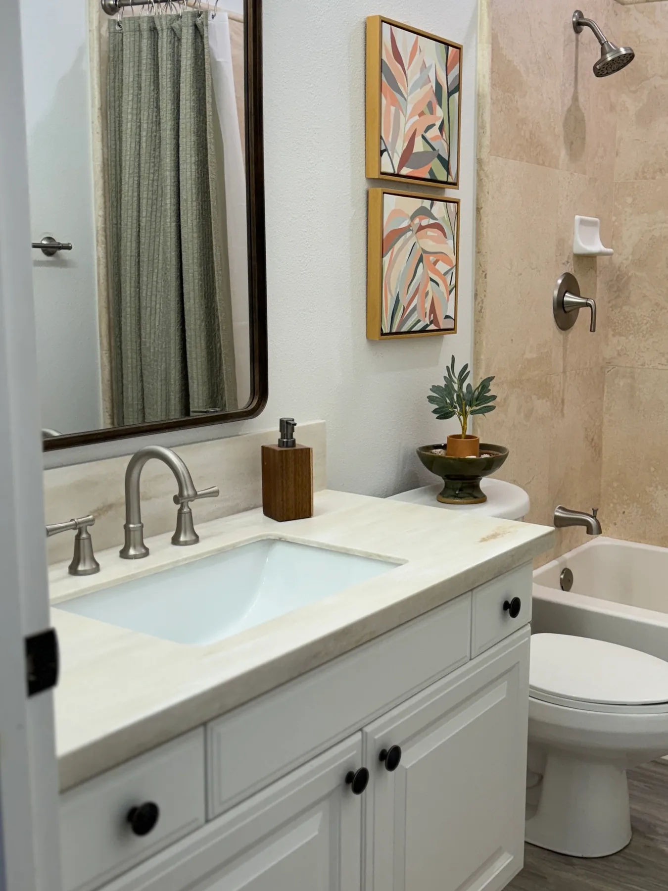 Un tocador de baño con lavabo está junto a una bañera y un inodoro.