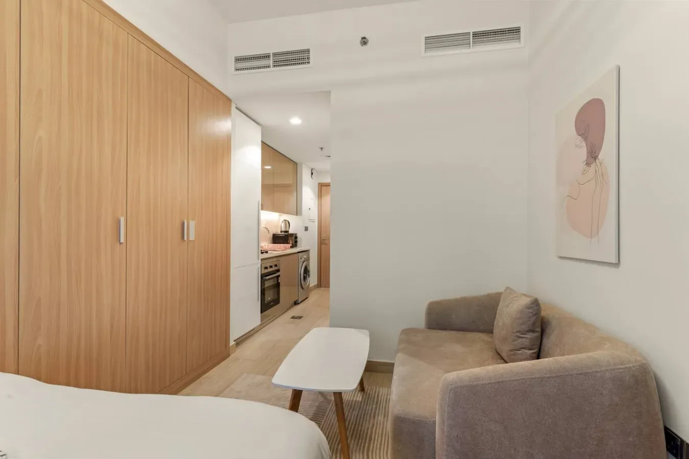 A bedroom seating area with a small table beside the bed.