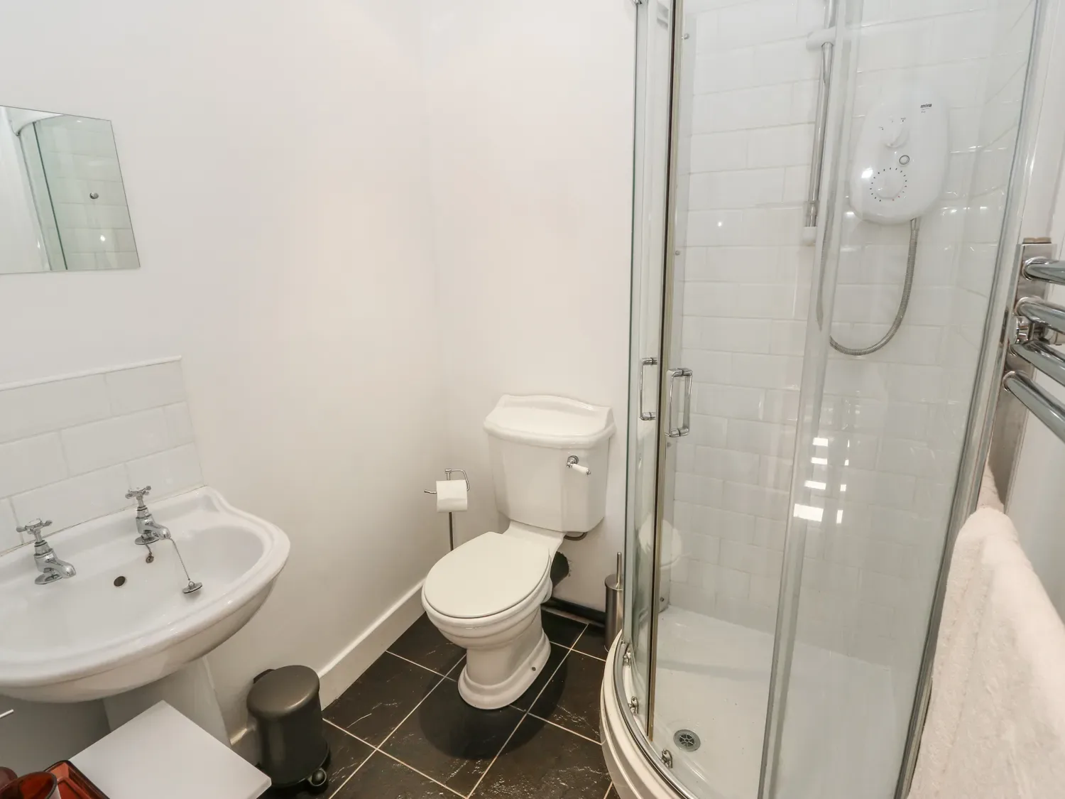 A bathroom with a sink, toilet, and shower.