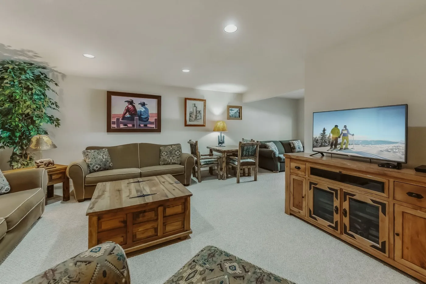 A living room with seating, a wooden coffee table, and a television.