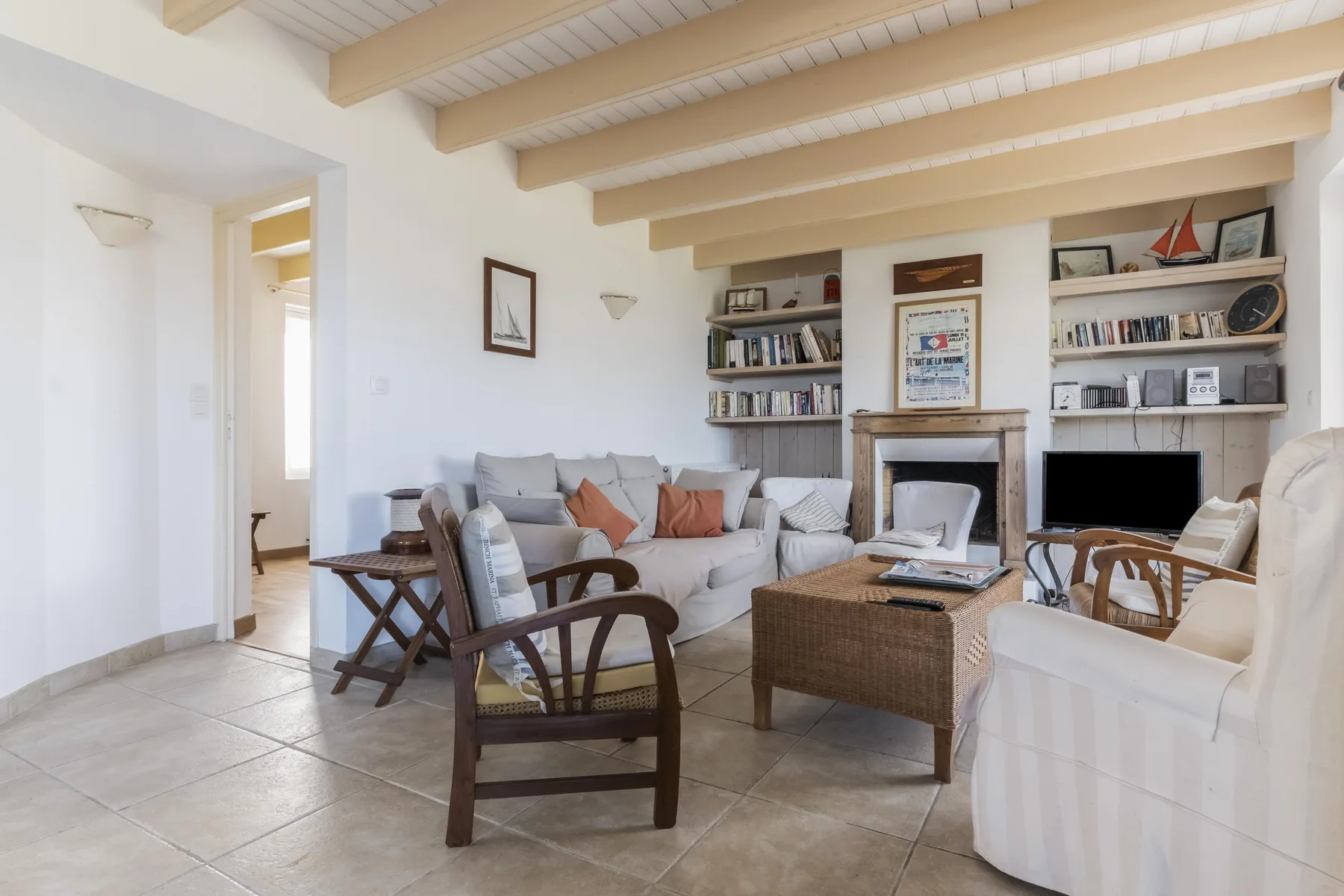 A bright living room with seating arranged around a low coffee table.