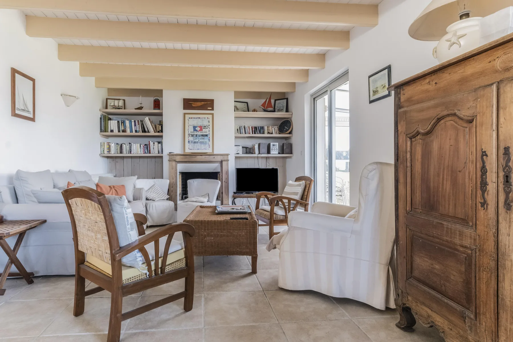 Living room with seating, built-in bookshelves, and a fireplace.