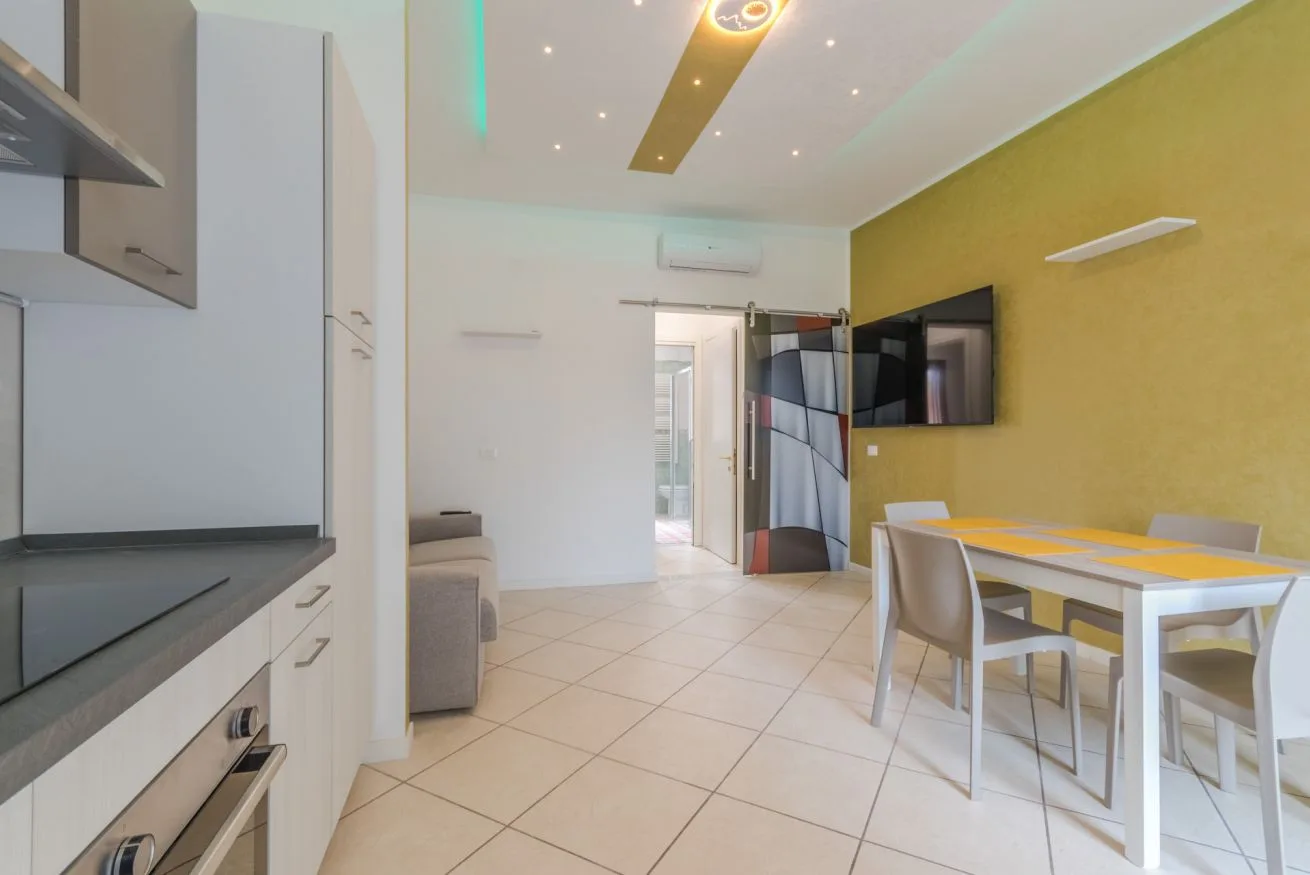 A bright open-plan living and dining area with a table and seating.