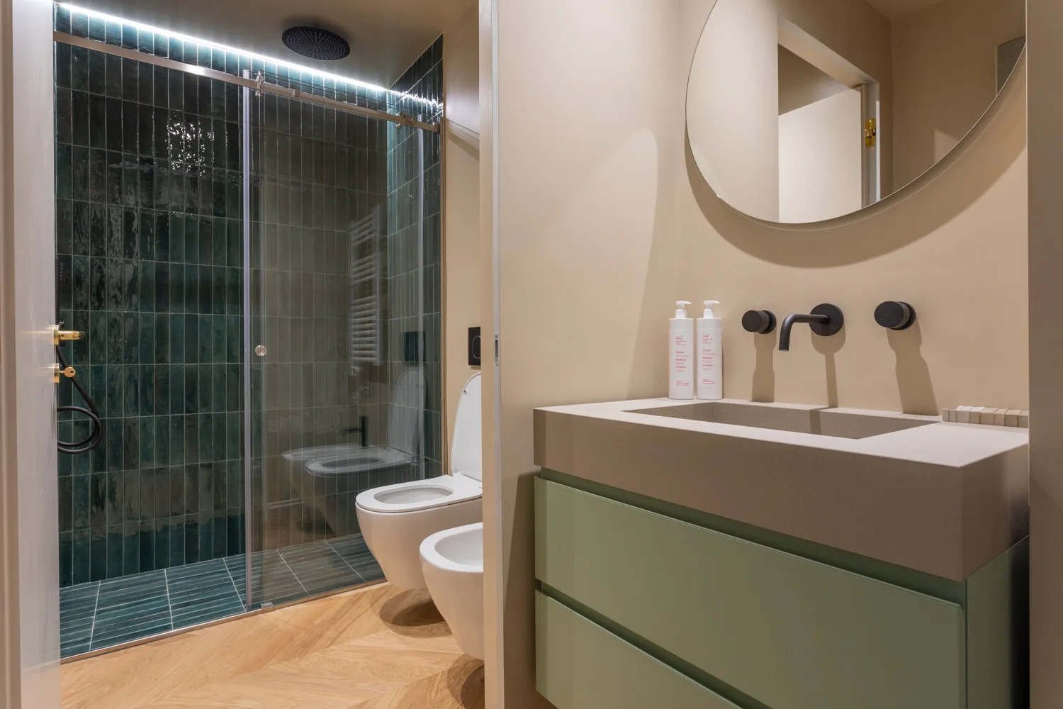 A bathroom with a glass shower and a double sink vanity.