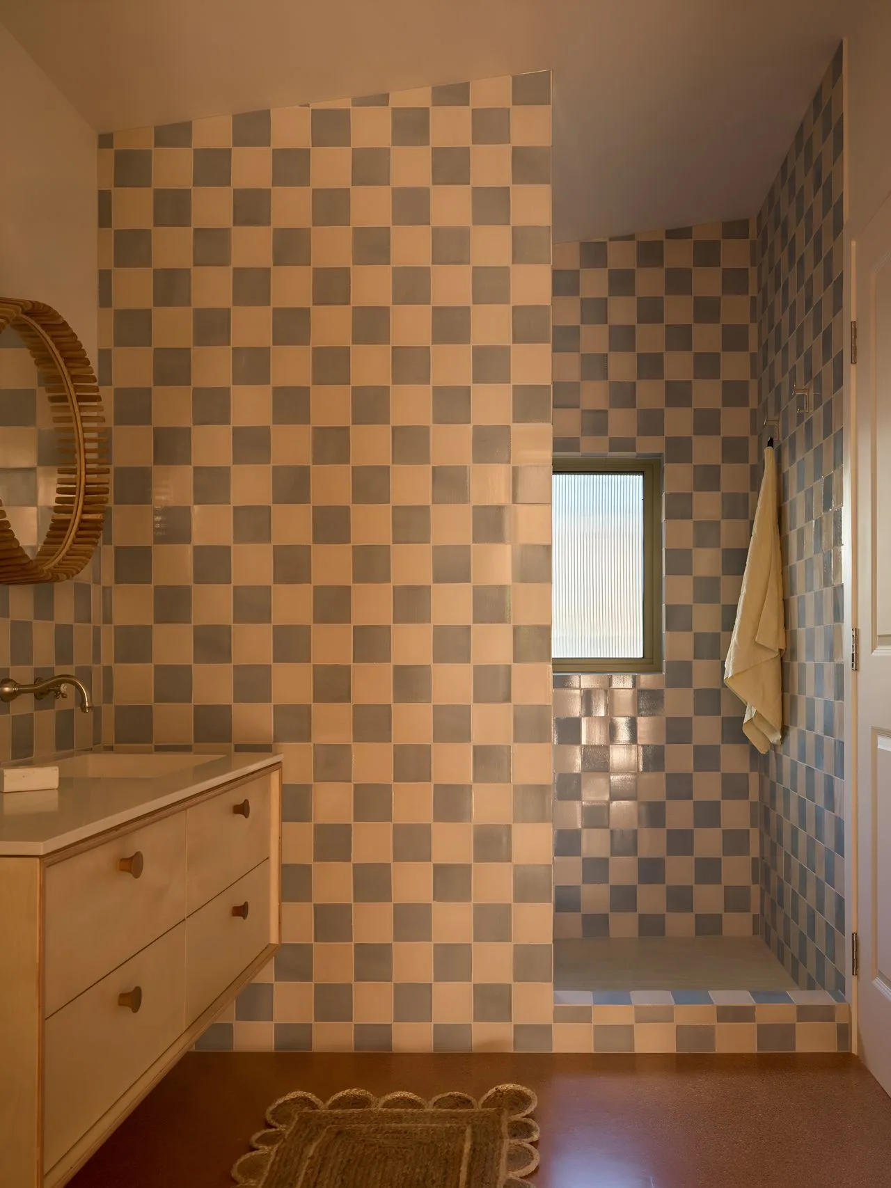 A tiled bathroom with a vanity, mirror, and shower.