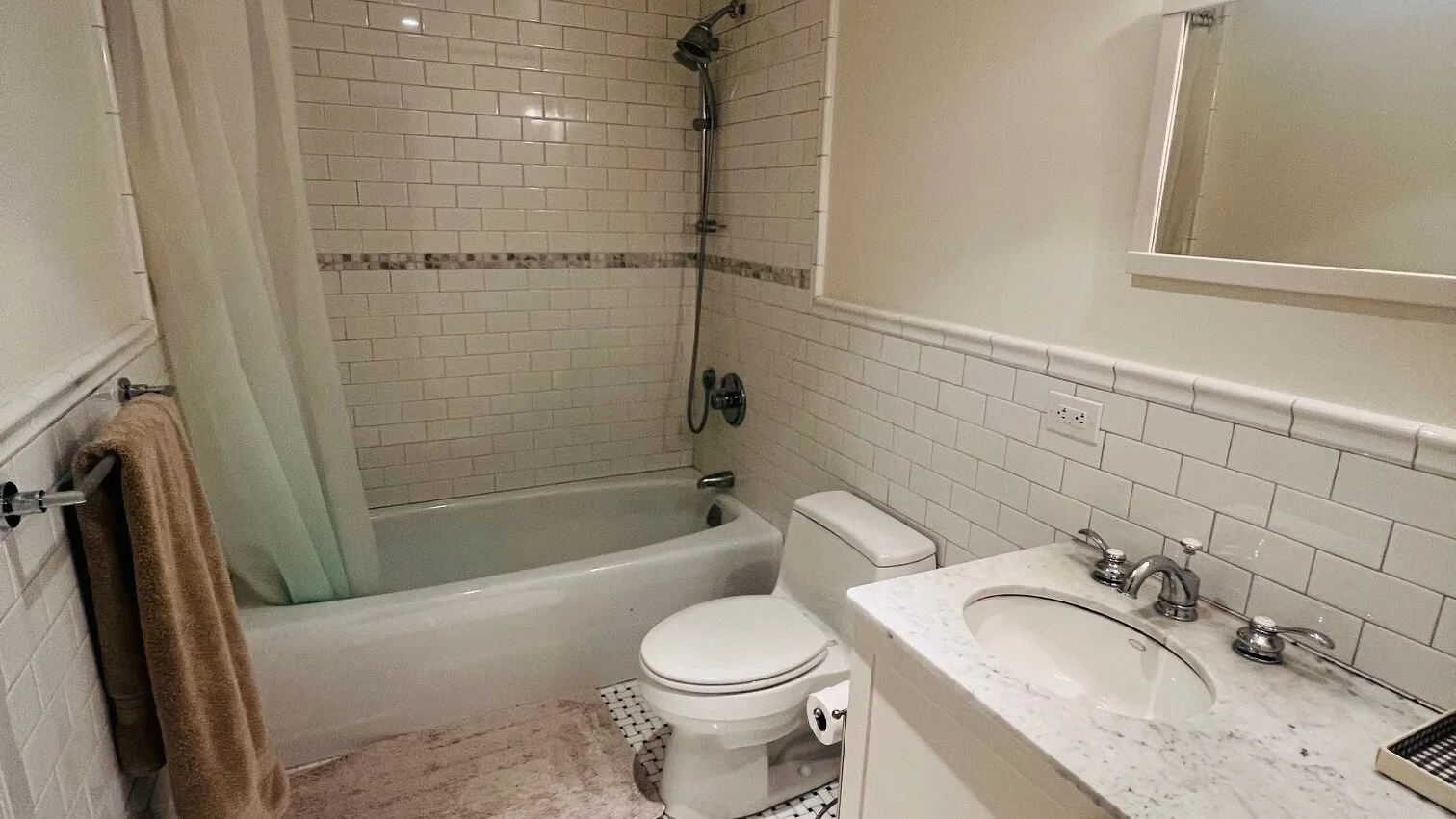 Un baño con bañera, ducha, inodoro y lavabo.