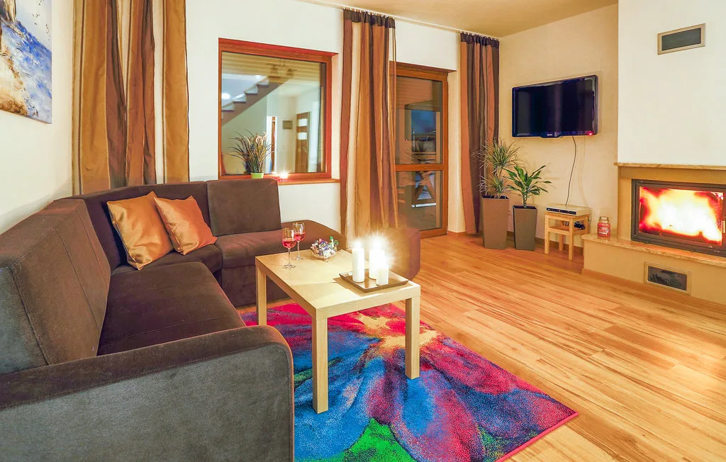 A living room with seating, a coffee table, and a fireplace.