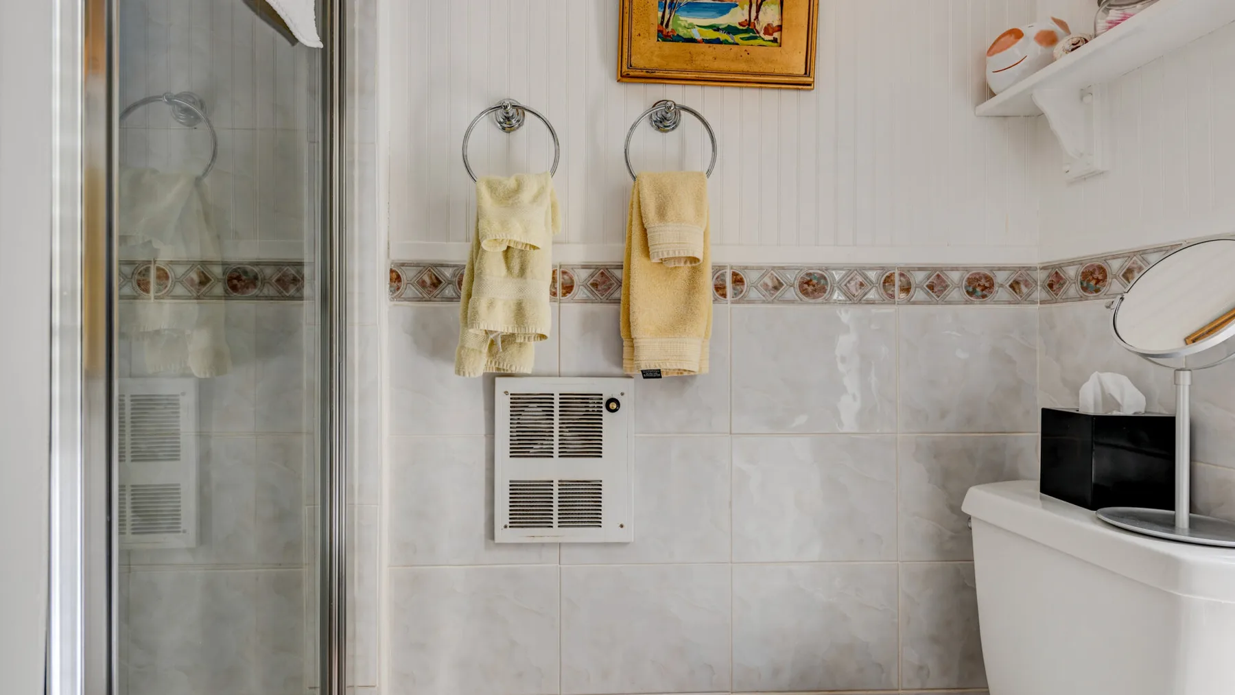 Un baño con azulejos, ducha y lavabo.