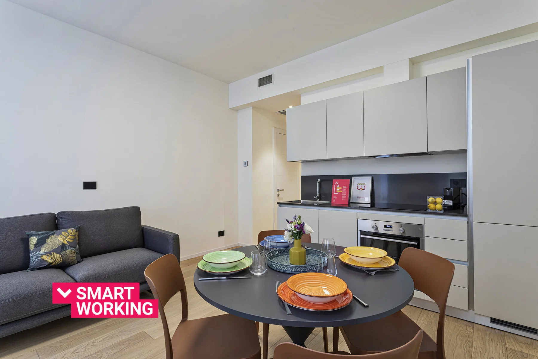 A compact kitchen and dining area with a table set for a meal.