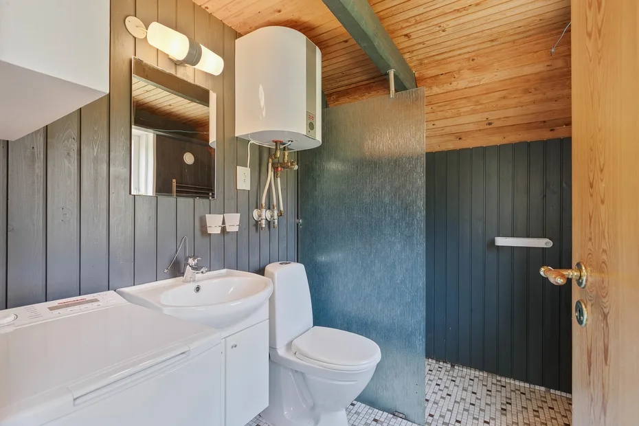 A bathroom with a sink, toilet, and shower.
