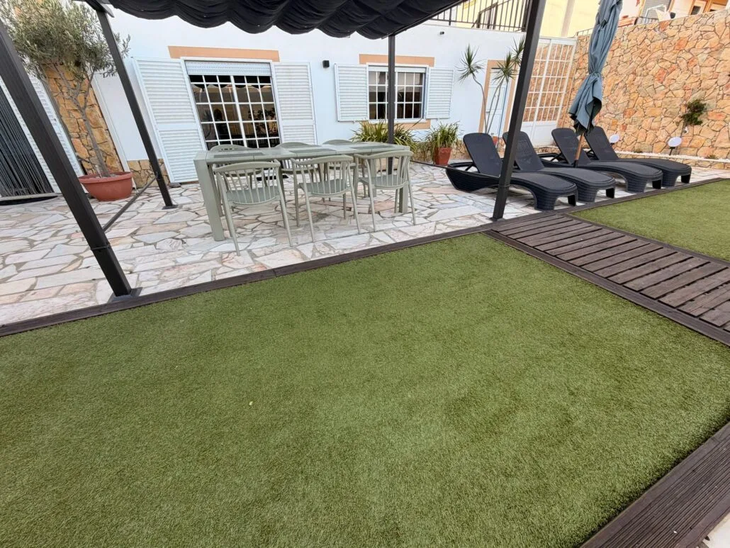 Terrace with lawn and sun loungers