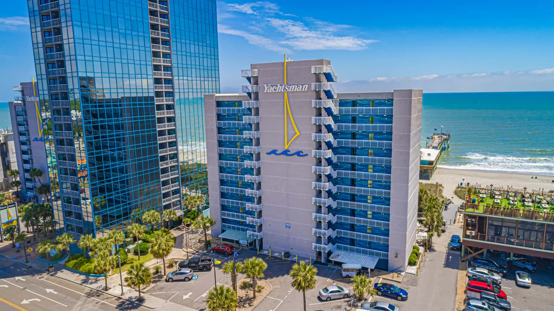Aerial view of beachfront high-rise buildings beside the ocean.
