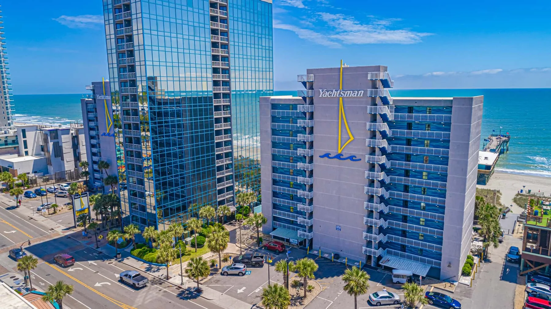 A coastal cityscape with glass high-rise buildings beside the ocean.