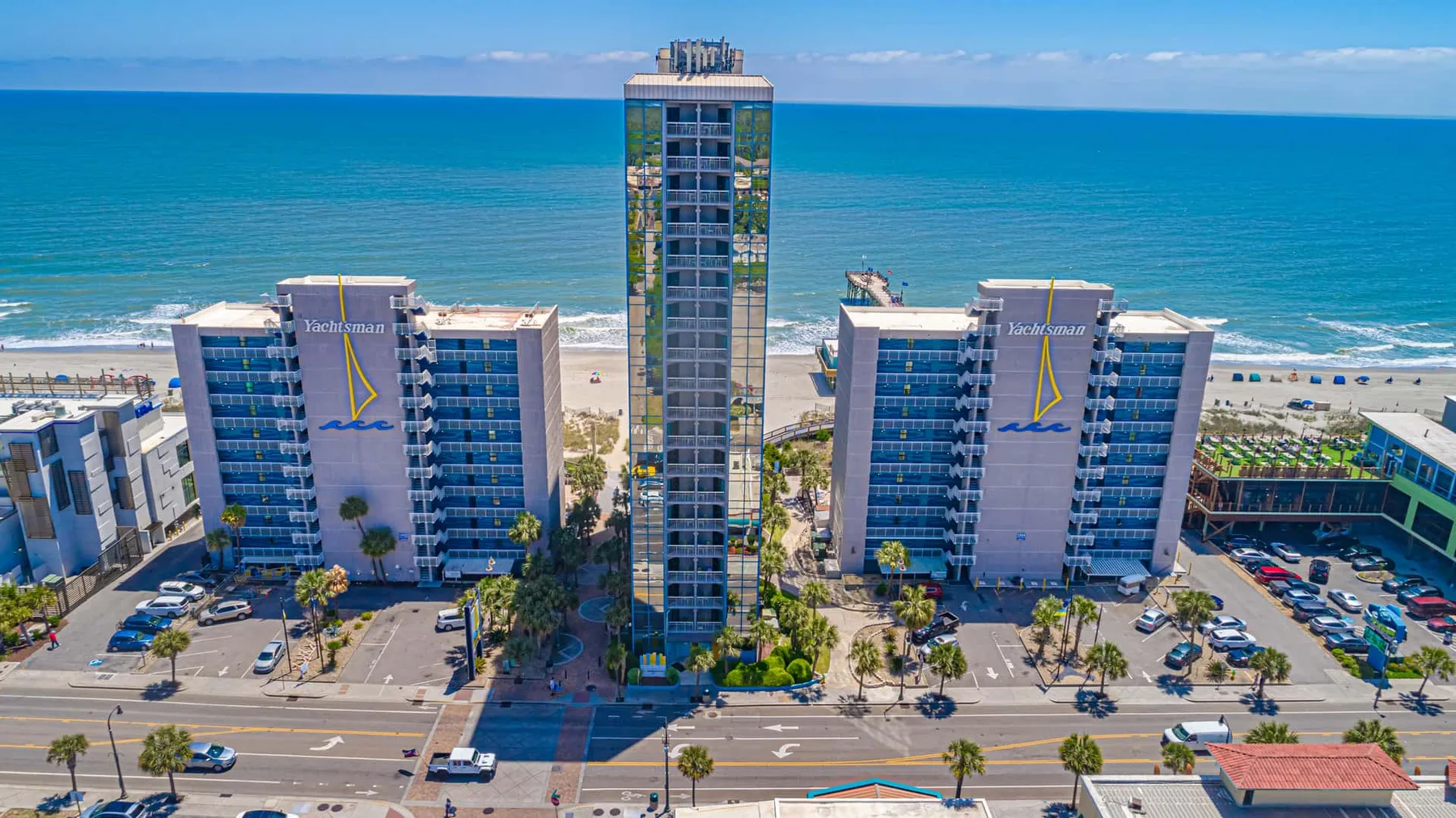 Aerial view of beachfront high-rise buildings beside the ocean.
