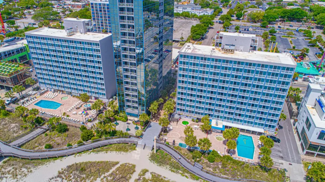 Aerial view of modern office buildings with a landscaped courtyard and swimming pool.