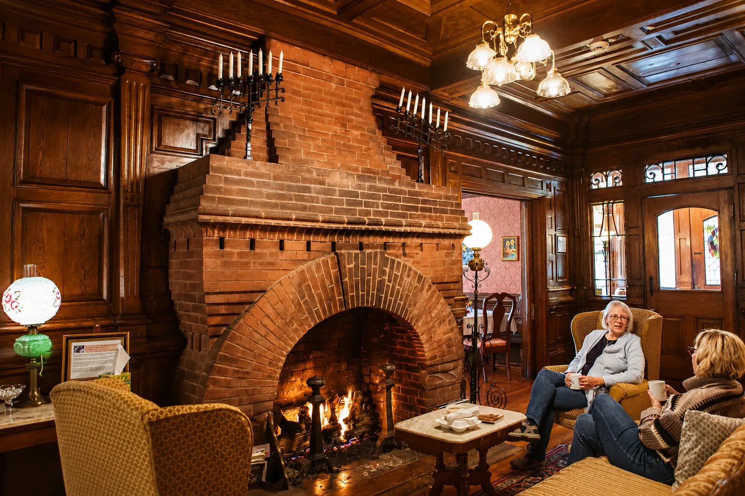 Huéspedes descansando junto a una chimenea en el interior histórico de la posada