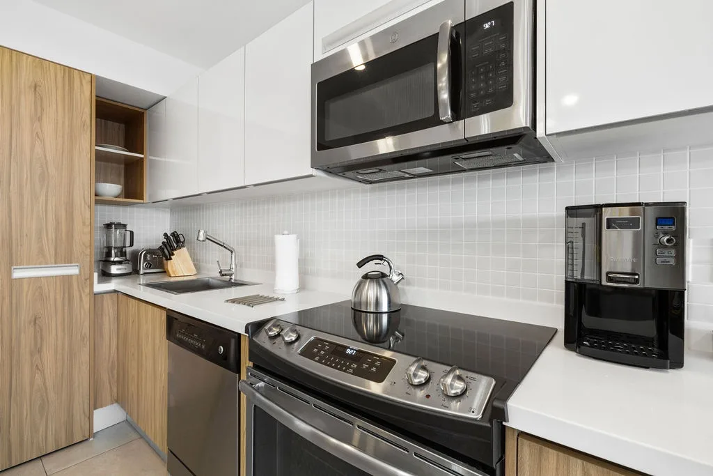 Your sleek, modern kitchen features stainless steel appliances, a glass cooktop, and all the essentials you need to whip up a homemade meal during your stay.