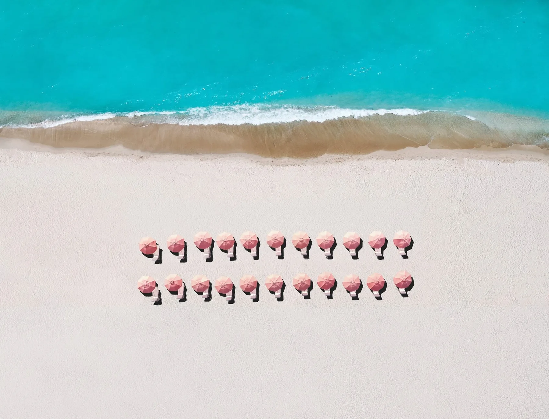 Beachfront with pink umbrellas