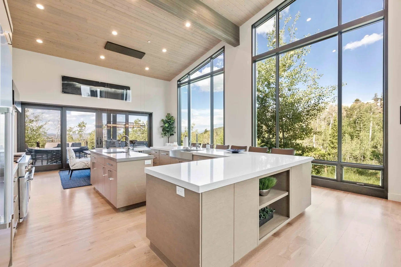 A bright, open kitchen with large windows and a central island.