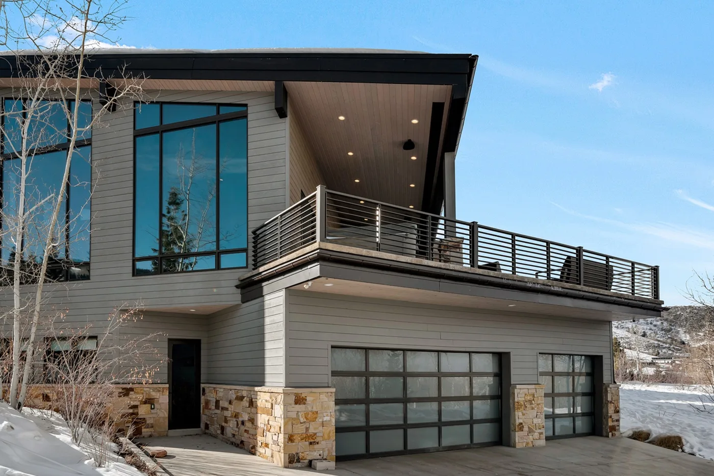 Modern house exterior with a balcony above the garage.