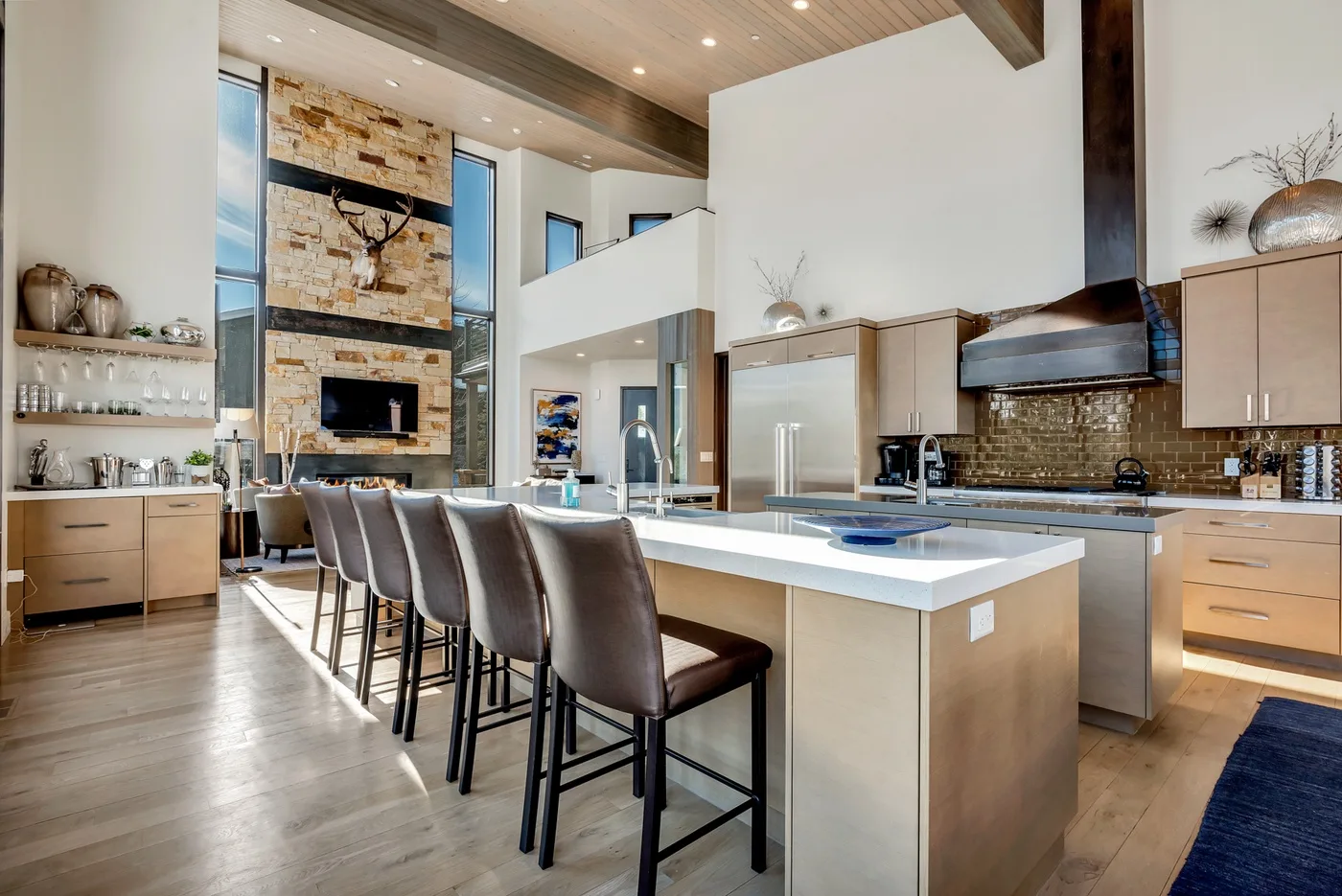 A spacious open-plan kitchen and dining area with an island and bar seating.