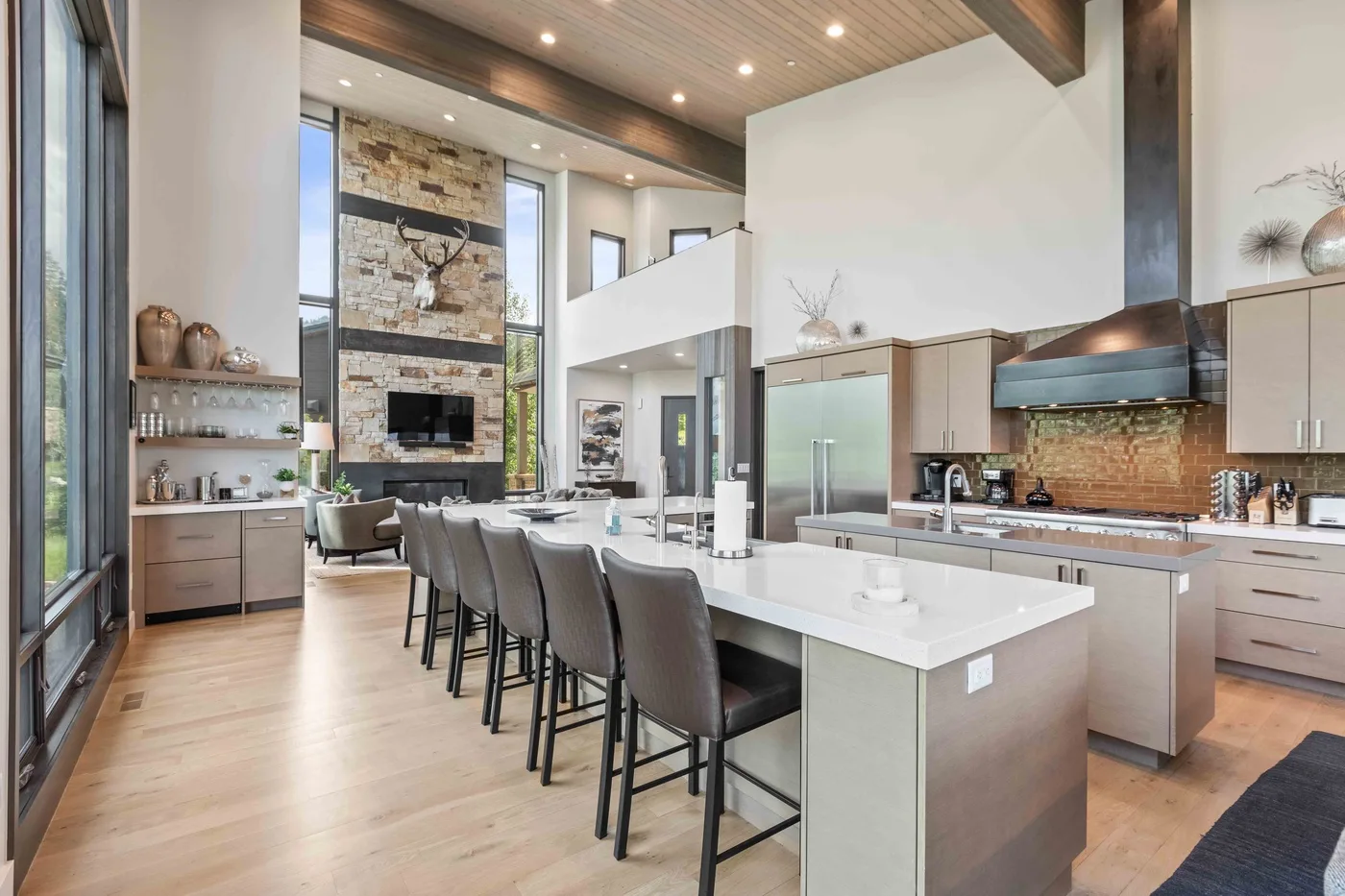 A spacious kitchen and dining area features a long island with seating.