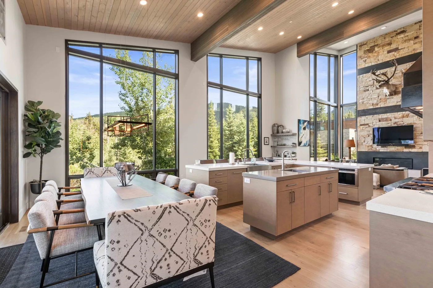 An open-plan kitchen and dining area with large windows and a central island.