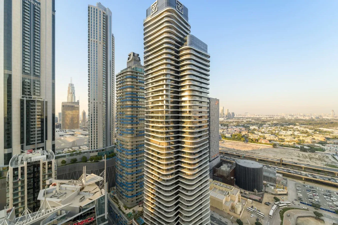 A cluster of modern high-rise buildings rises above the surrounding city.