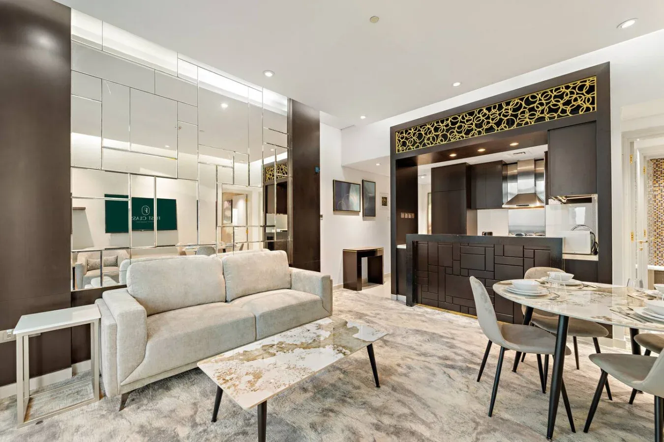 A modern lounge and dining area with seating, a table, and a mirrored wall.