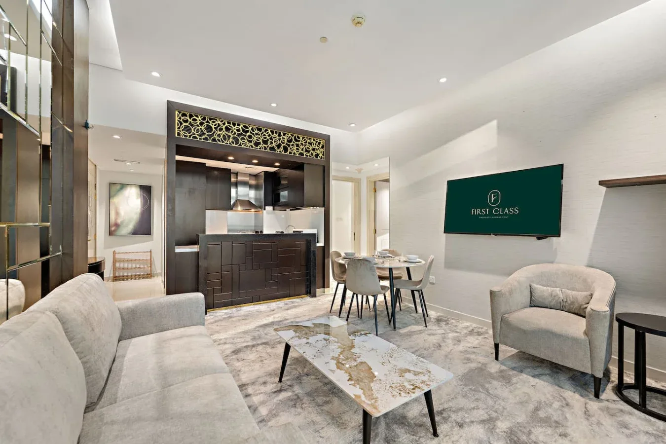 A modern living and dining area with seating, a table, and a wall-mounted television.
