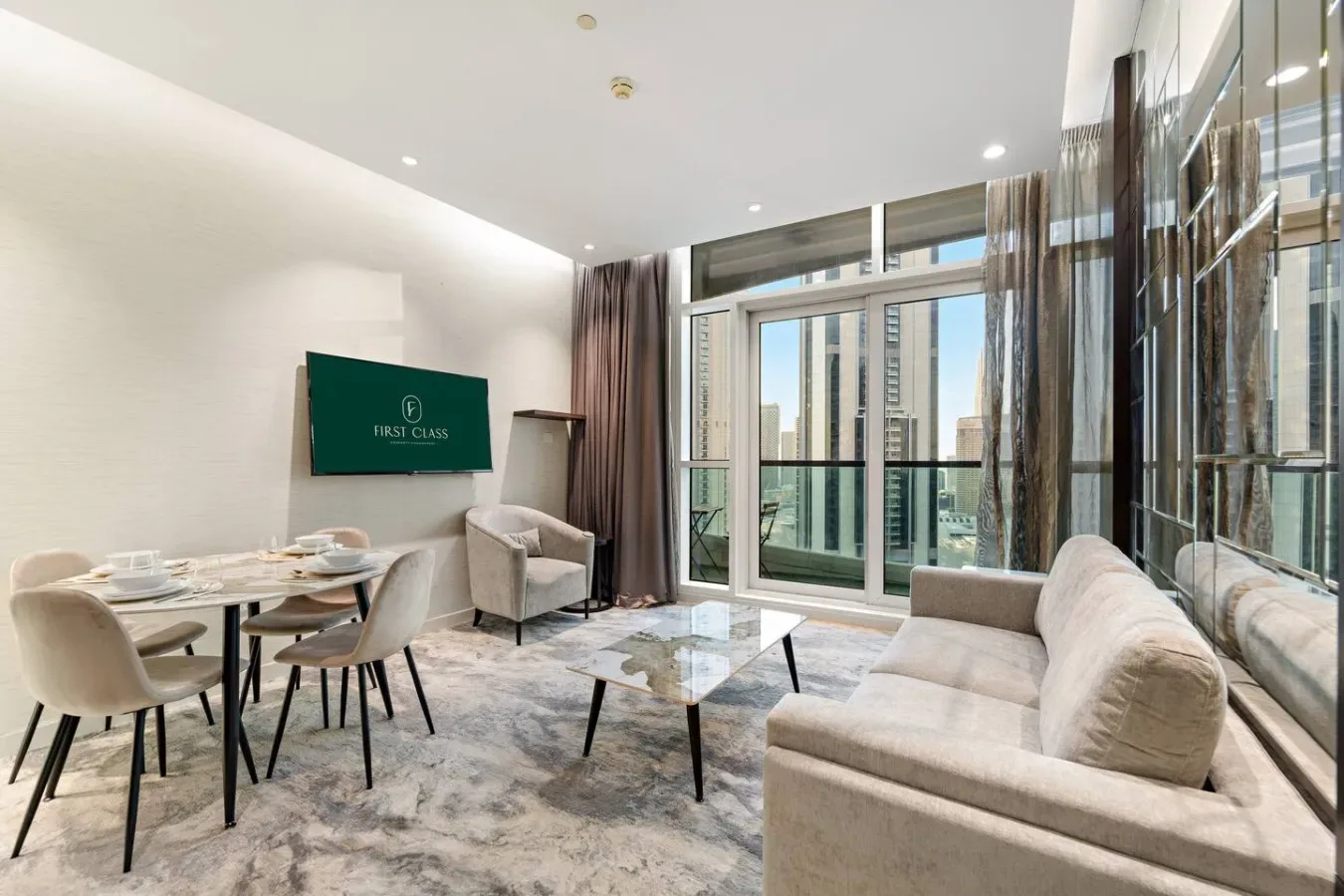 A bright living and dining area with seating beside large windows.