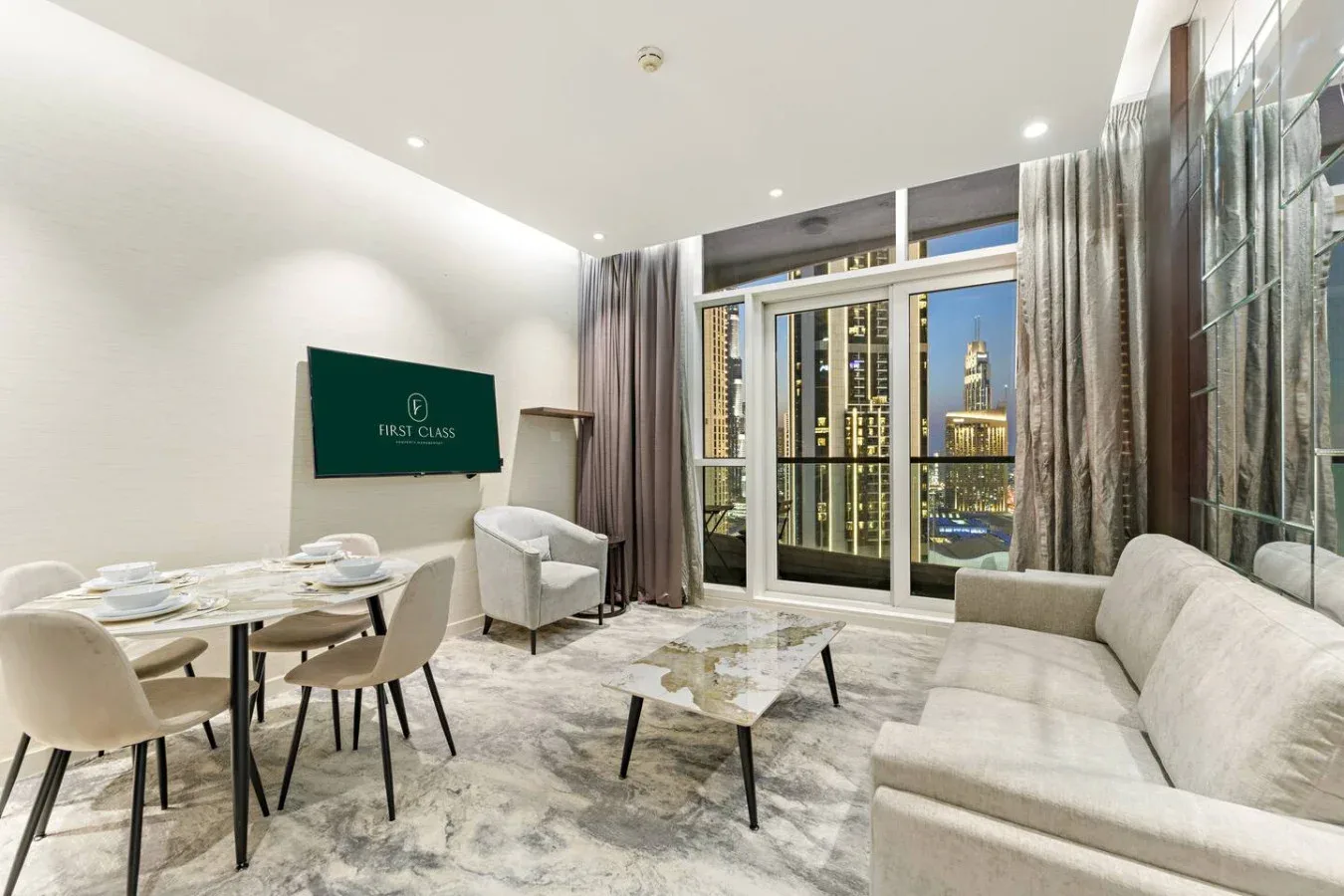 A modern living room with a dining table and seating beside large windows.