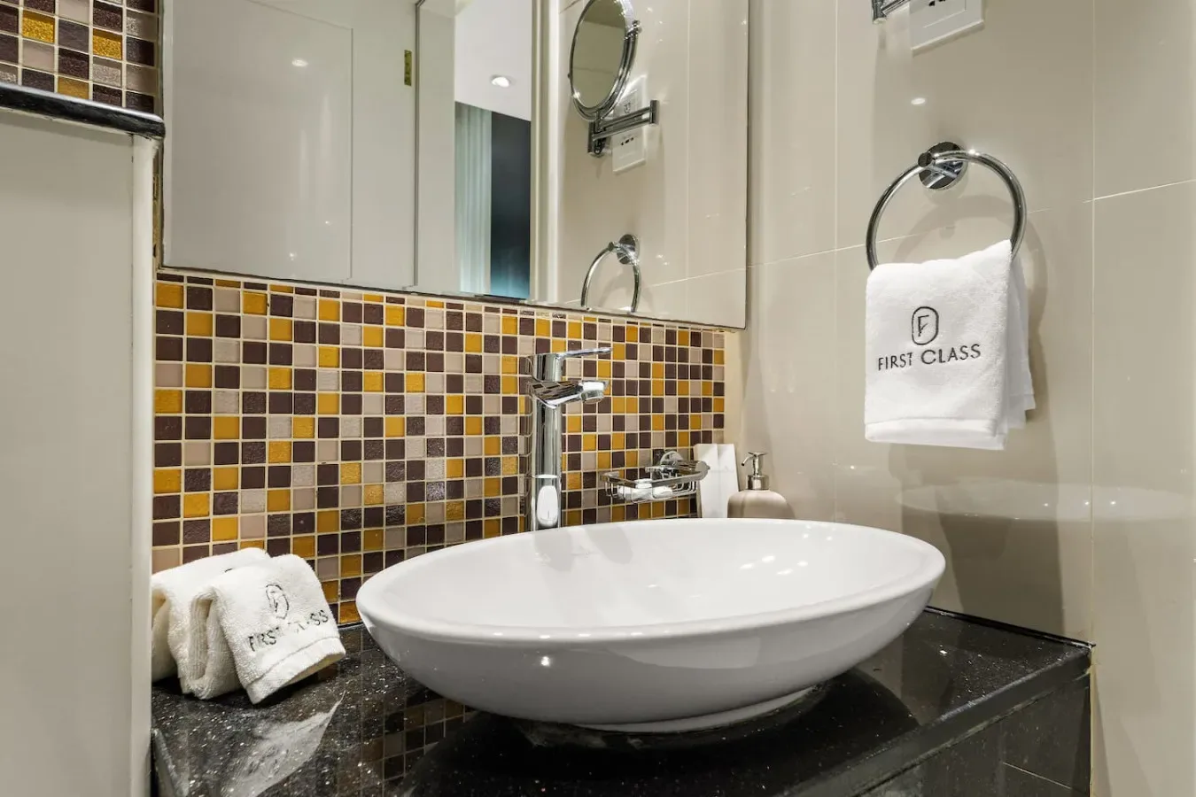A bathroom vanity with a white vessel sink and a tiled backsplash.
