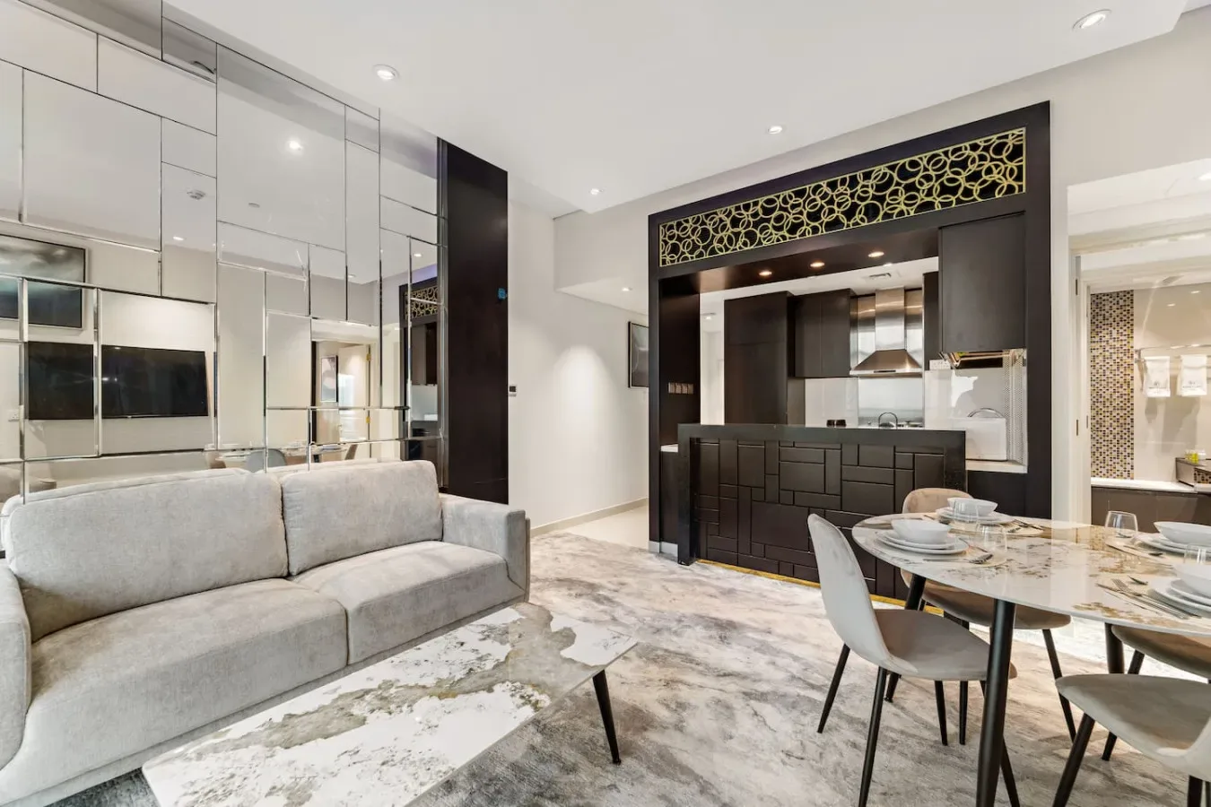 A modern open-plan living and dining area with a kitchen beyond.