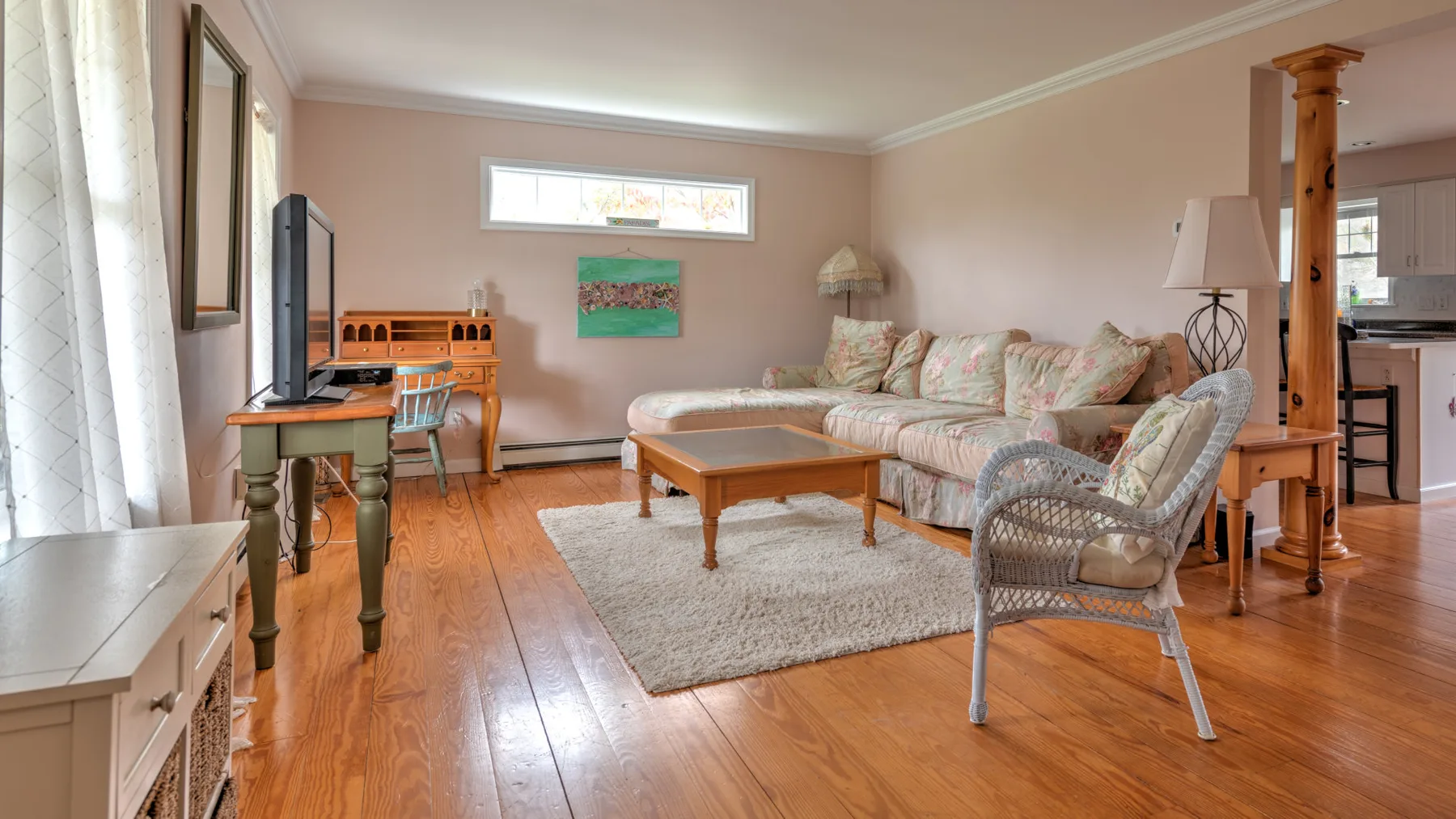 A living room with seating arranged around a wooden coffee table.
